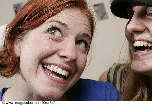 Young women laugh together.