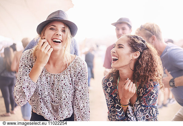 Young women laughing at music festival