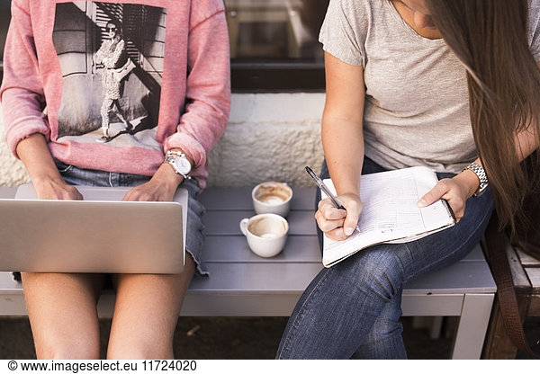 Young women studying and using laptop