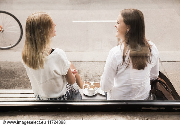 Young women talking outside of cafe
