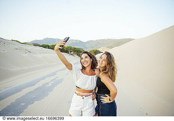 Young women with mobile phones are excited and happy