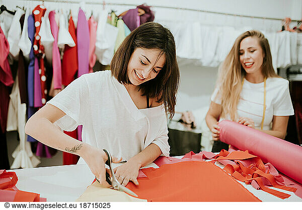 young women working together in a design studio. they laught