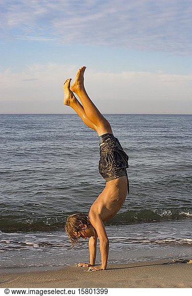 Youth doing a handstand at the Baltic Sea beach  Kühlungsborn  Baltic Sea  Mecklenburg-Western Pomerania  Germany  Europe