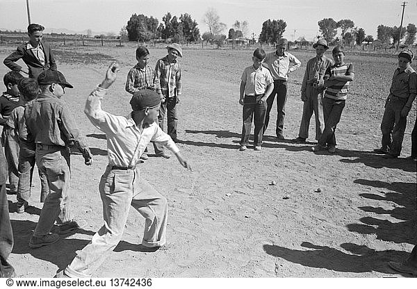 Yuma  Arizona: March  1942 A boy throwing a top duirng a top spinning contest at the annual field day at the Farm Security Administration farmworkers community.