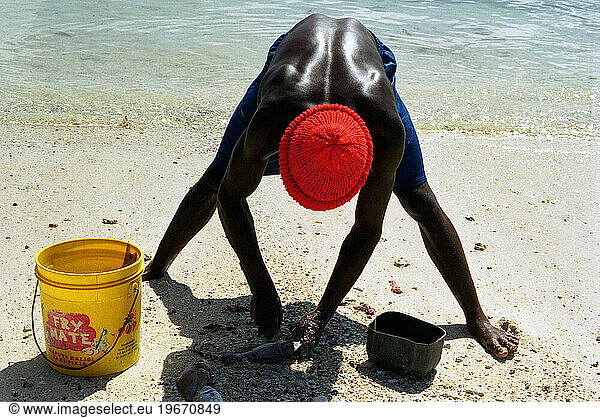 Zanzibari fisherman filleting his catch. Kizimkazi village  south west Zanzibar. Tanzania