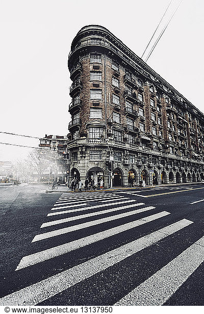 Zebra crossing by Wukang Mansion against clear sky