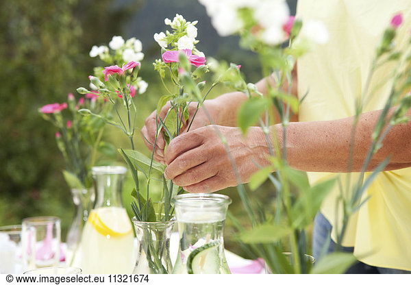 Mature woman decoration garden table for birthday party