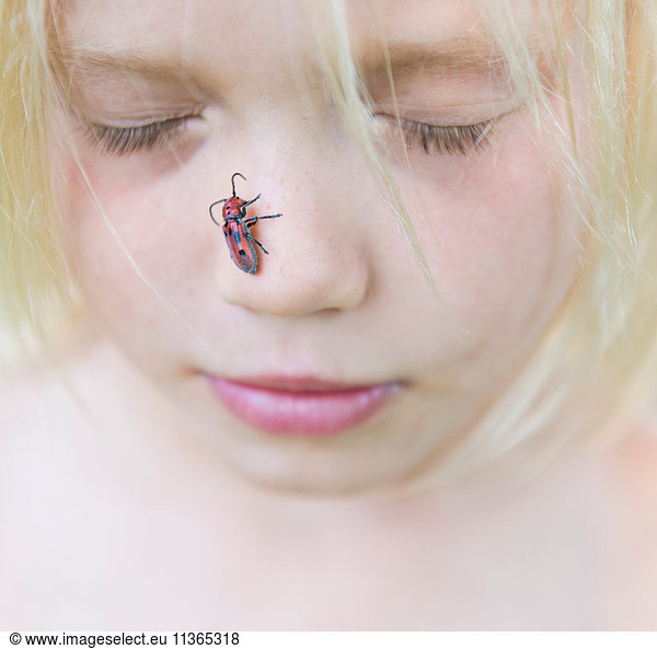 Boy with insect on nose
