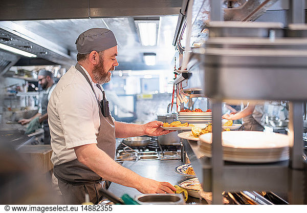 Chef preparing dishes in Italian restaurant kitchen